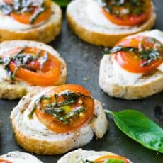 Caprese Crostini are an easy and tasty appetizer to serve at parties. They only take about 10 minutes to assemble, but they look fancy and taste great.