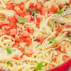 This chicken pasta has a creamy and light tomato alfredo sauce. The sauce has very little cream but it tastes gourmet! An easy chicken pasta recipe. | natashaskitchen.com