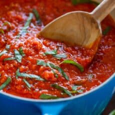 Marinara Sauce in Saucepan garnished with basil for Italian marinara