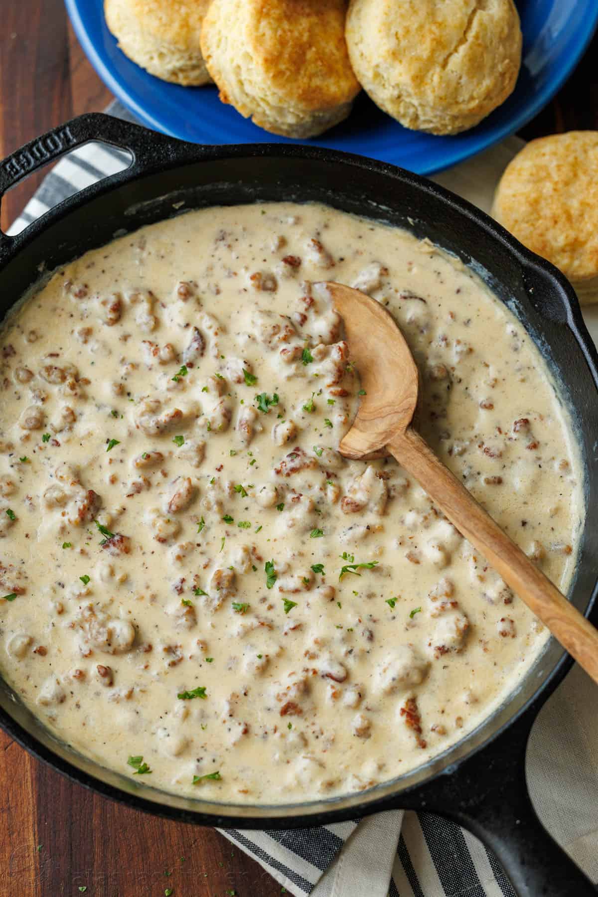 Easy Sausage gravy and biscuits breakfast served on blue plates